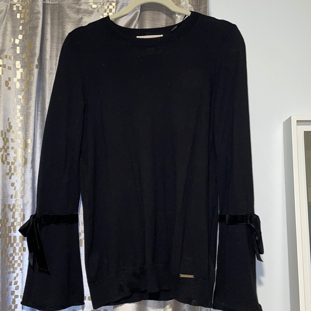 MK: black designer sweater with suede wrist bow